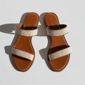 Flat African leather sandals with beaded straps, top-down view, placed on white background with no shadows, elegant product styling”